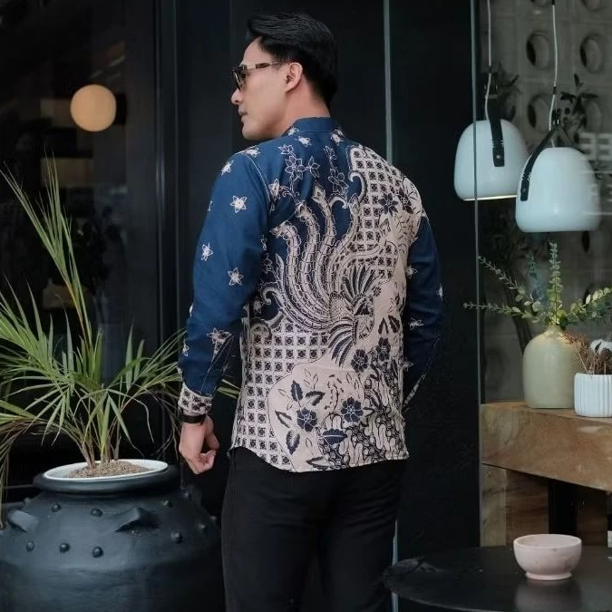 Rear full view of contemporary batik shirt with detailed navy blue and beige traditional pattern showcasing geometric grids and botanical motifs on back, modern smart casual menswear.